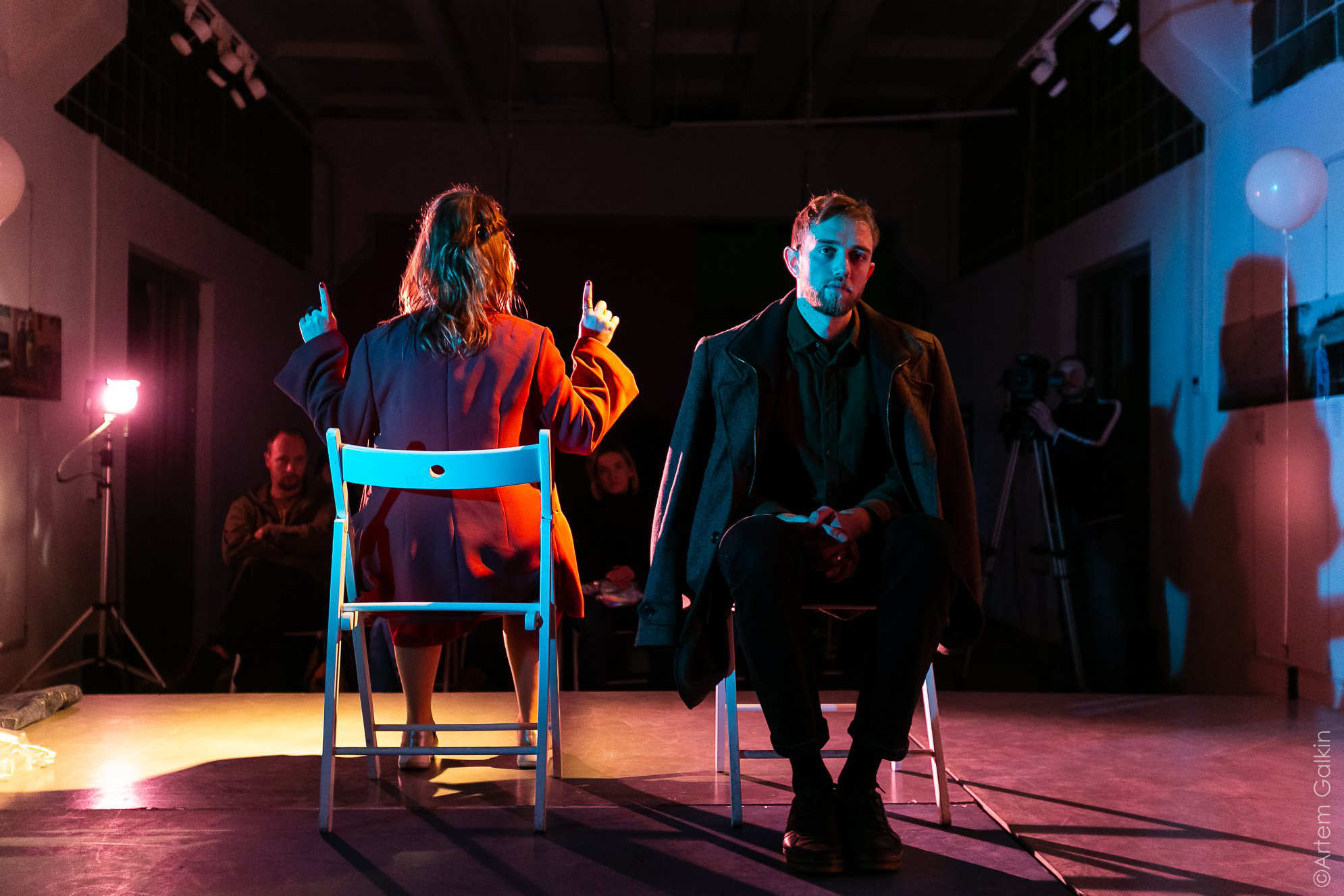 a man and a woman sit facing away from each other in a new Ukrainian play